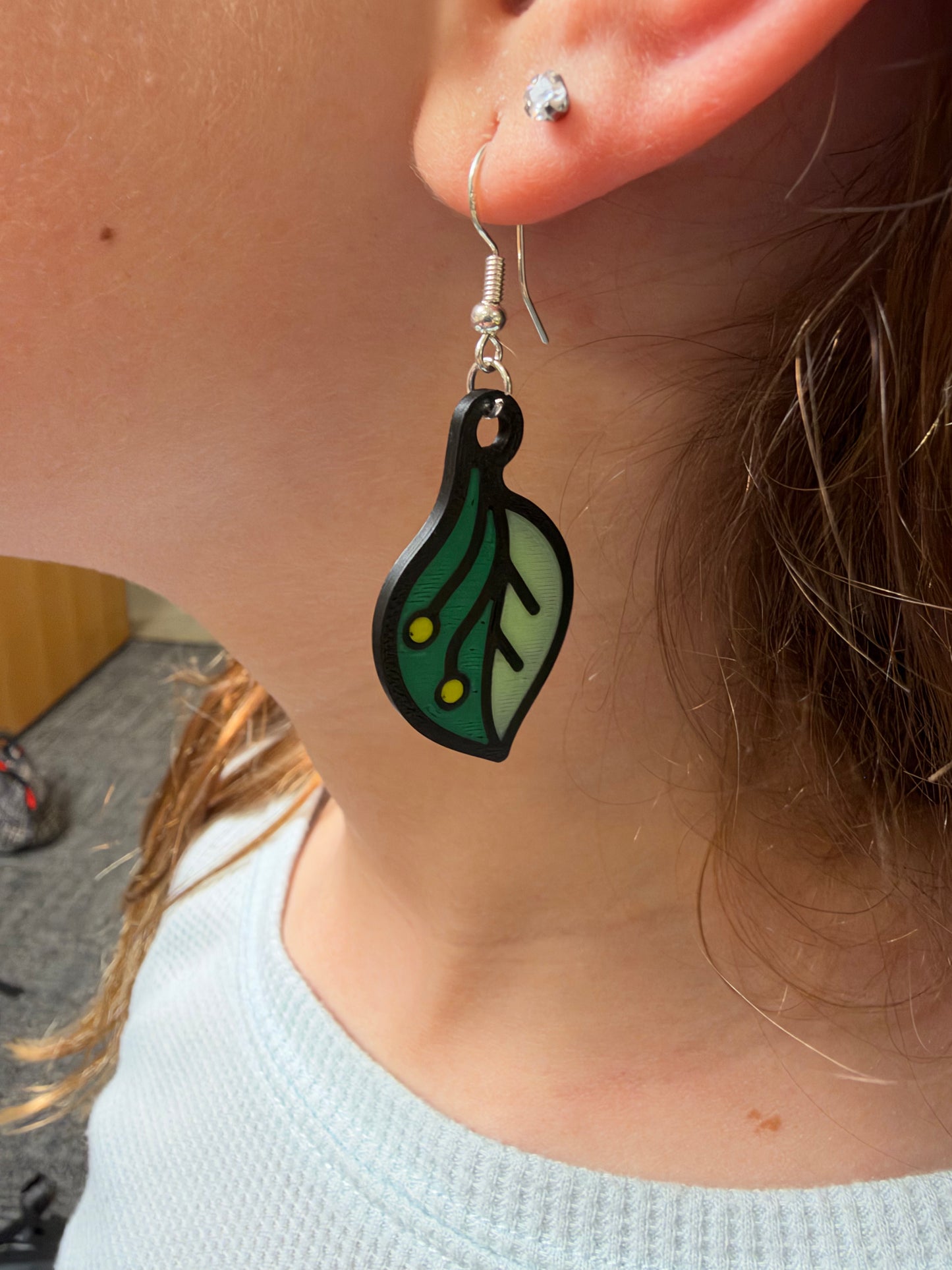 Girl wearing a bioglow earring.